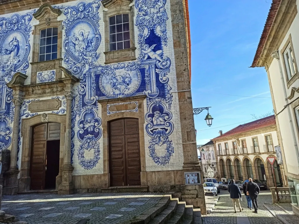 Portuguese Tiles - Decorative tile facade of a church featuring religious motifs.