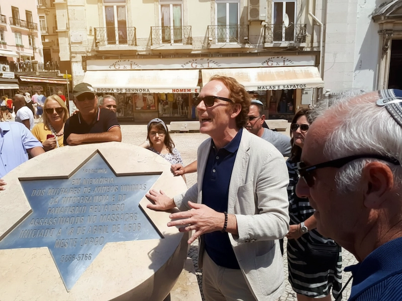 Guests learning about Lisbon’s Jewish memorial with their guide during a custom Jewish heritage tour in Portugal.